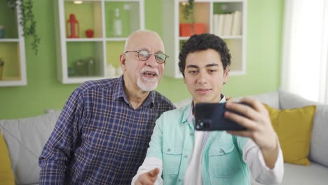 Cute-grandfather-and-grandson-posing-for-phone-cameras.